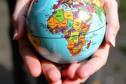 freepik__a-persons-hands-holding-a-colorful-globe-of-the-wo__87740