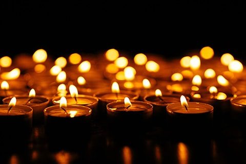 Candles. Set of lighting candles in dark. Selective focus