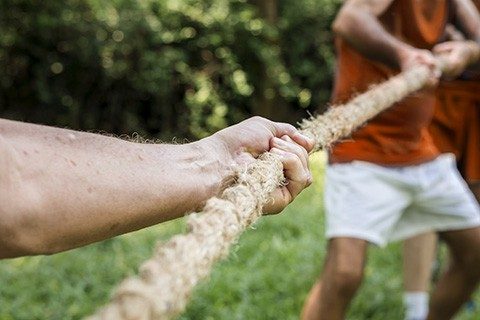 Mature people in tug of war