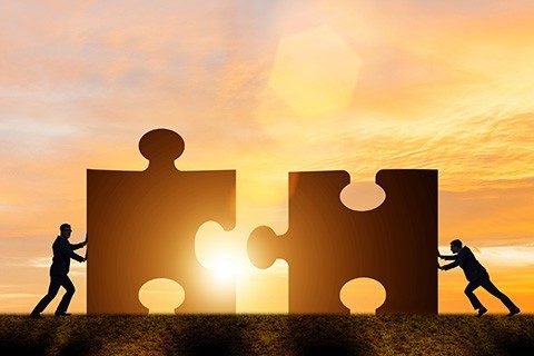 Business concept of teamwork with jigsaw puzzle