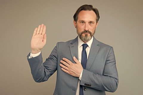 I swear. Senior lawyer make oath grey background. Mature man hold hand on heart and open palm. Pledge of allegiance. Business lawyer. Lawyer or attorney at law. Law and justice. Good lawyer knows law.